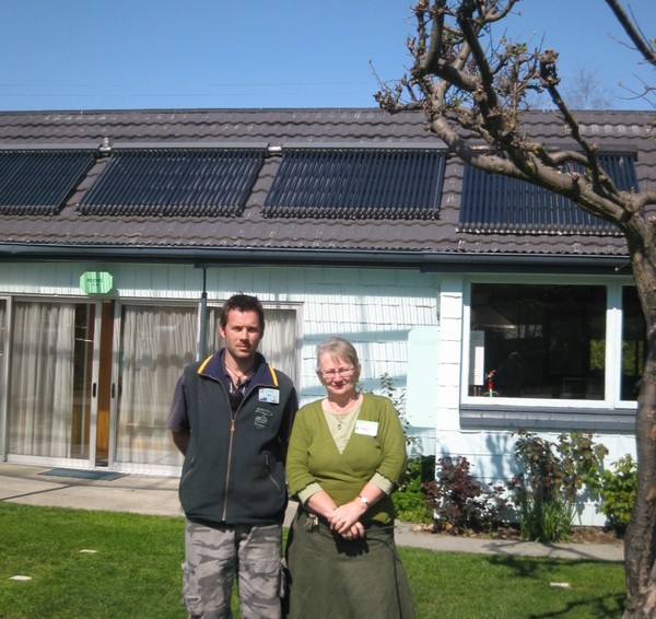 Erna and son, Michael Spijkerbosch in the Creeksyde grounds with solar panels in the background
